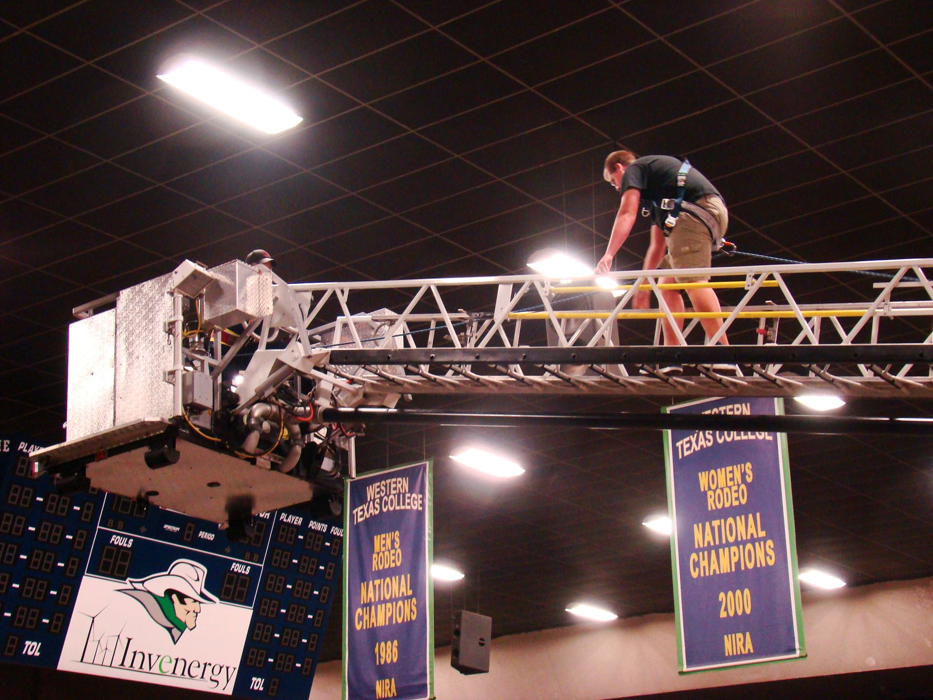 Student climbs ladder extended from fire truck.